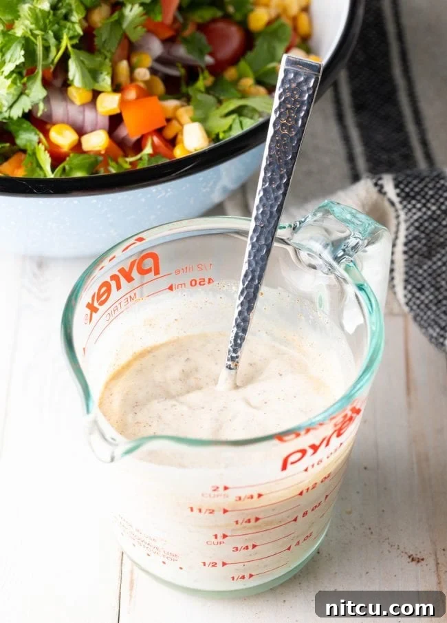 Close-up of creamy southwest ranch dressing in a bowl, showing its rich texture.