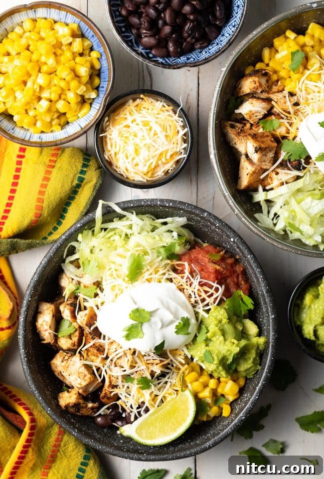 Assortment of fresh Southwestern toppings for burrito bowls, including salsa, guacamole, corn, beans, and shredded lettuce.