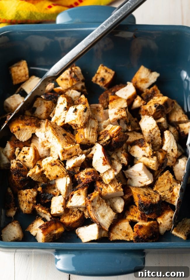 Close-up of perfectly chopped chipotle grilled chicken, ready for assembly.