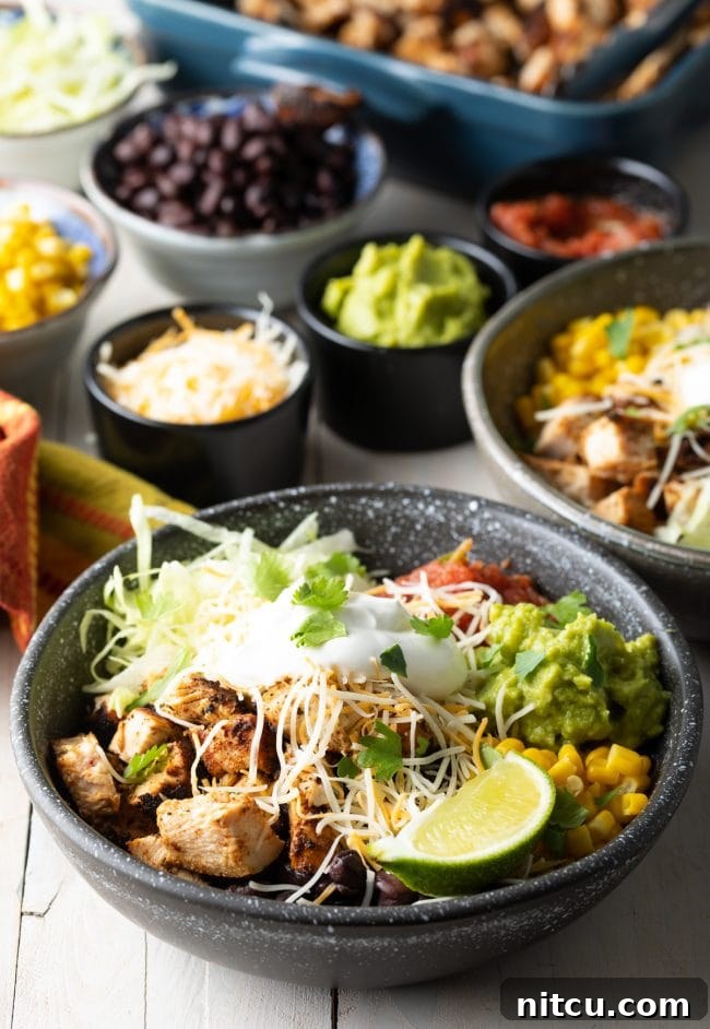 A fully assembled Chipotle Chicken Burrito Bowl, brimming with grilled chicken, rice, beans, corn, and all the fresh toppings.