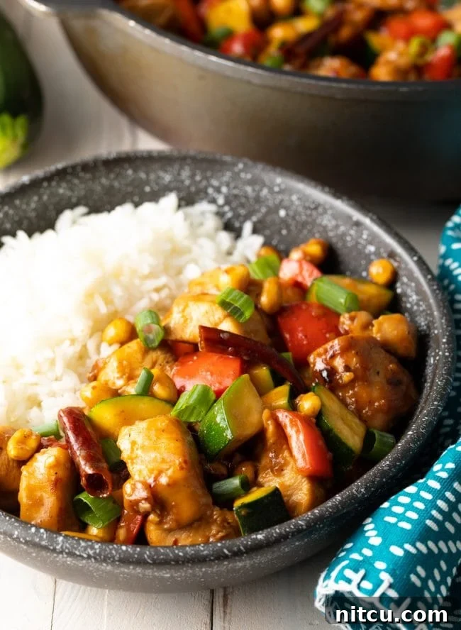 Black bowl served with some white rice and the best kung pao chicken recipe