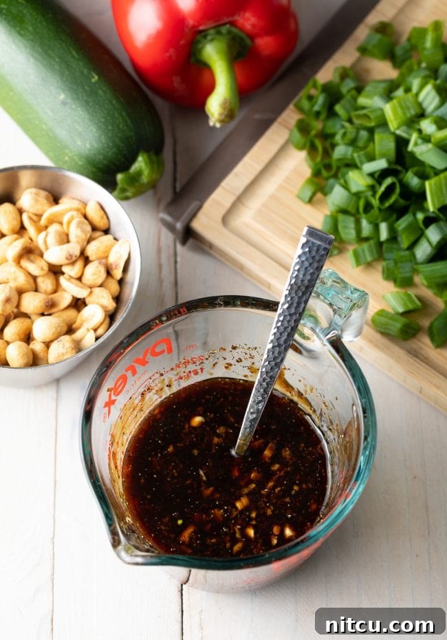 Glass measuring pitcher with stir fry sauce.