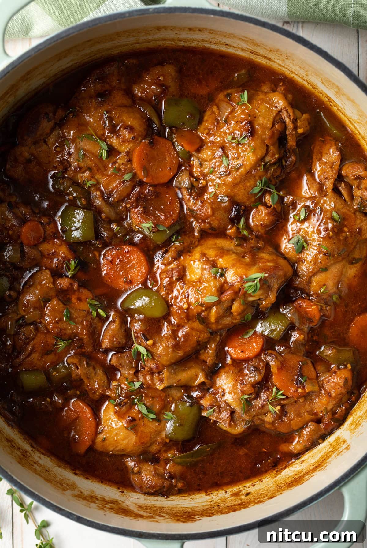 Top down view of a pot filled with tender chicken stew.