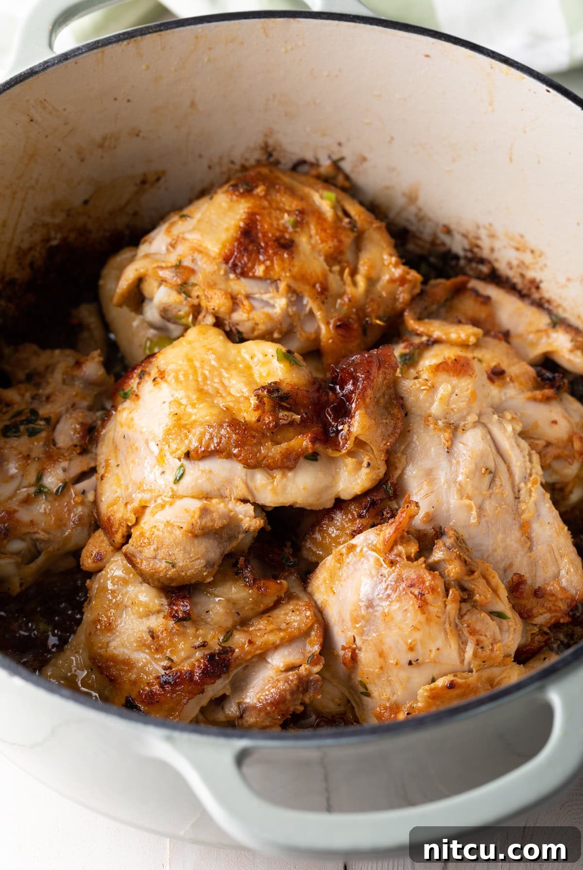 Browned chicken in a pot.