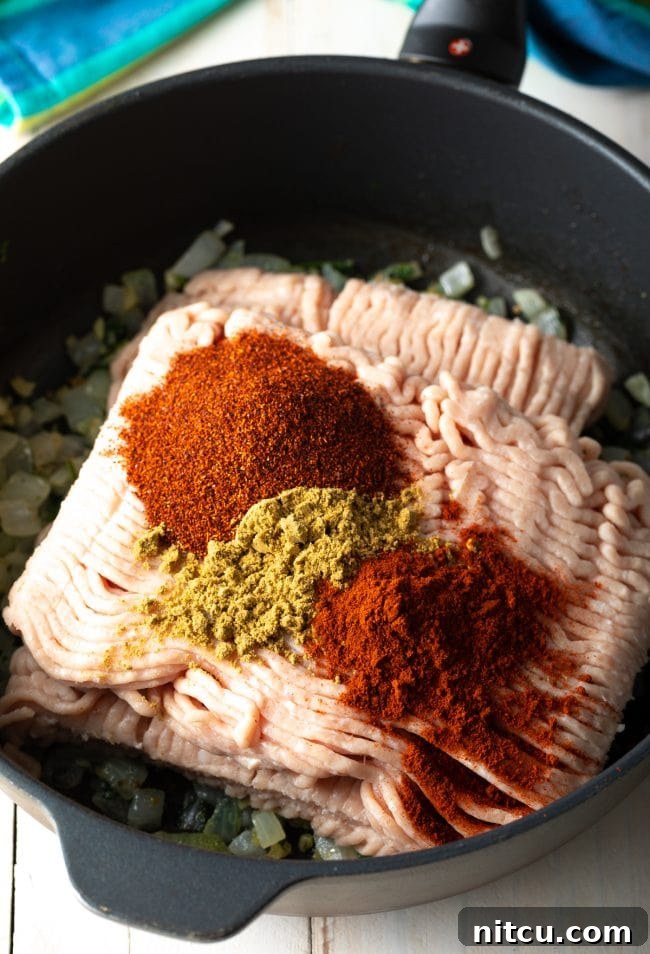 Ingredients for ground turkey tacos simmering in a skillet