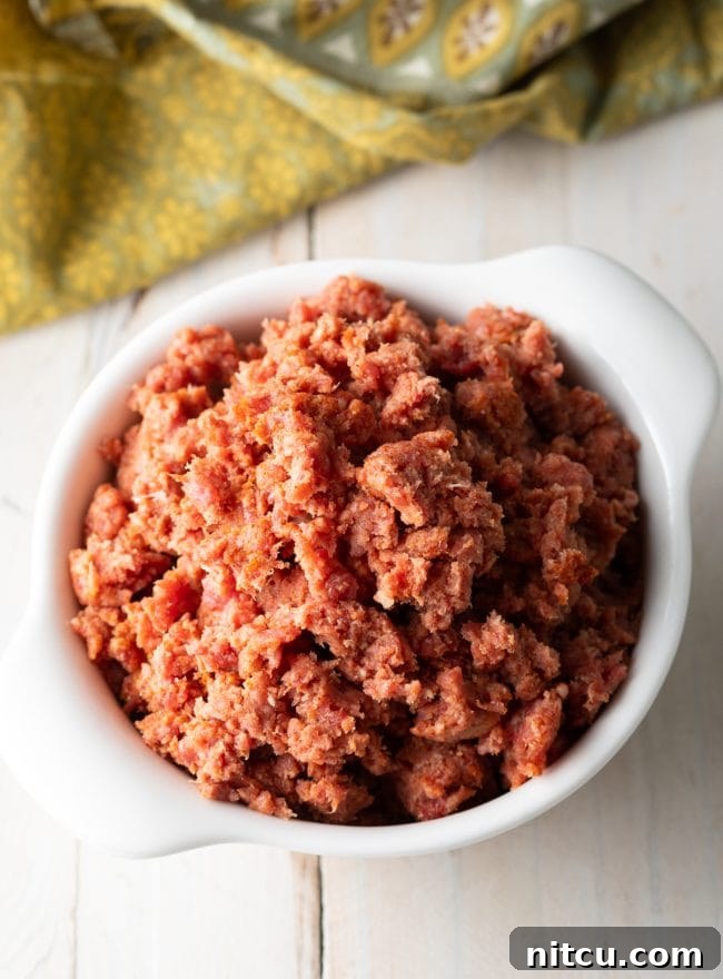 Freshly prepared beef tartare, Kitfo, served in a pristine white bowl.