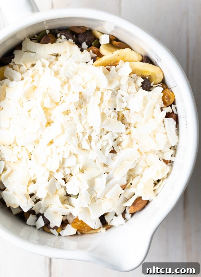 Healthy trail mix in a white bowl, ready for snacking.