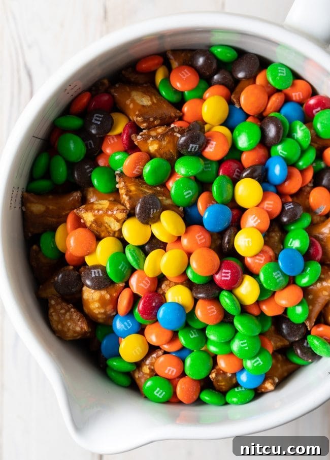 Indulgent trail mix in a white bowl, featuring a rich assortment of treats.
