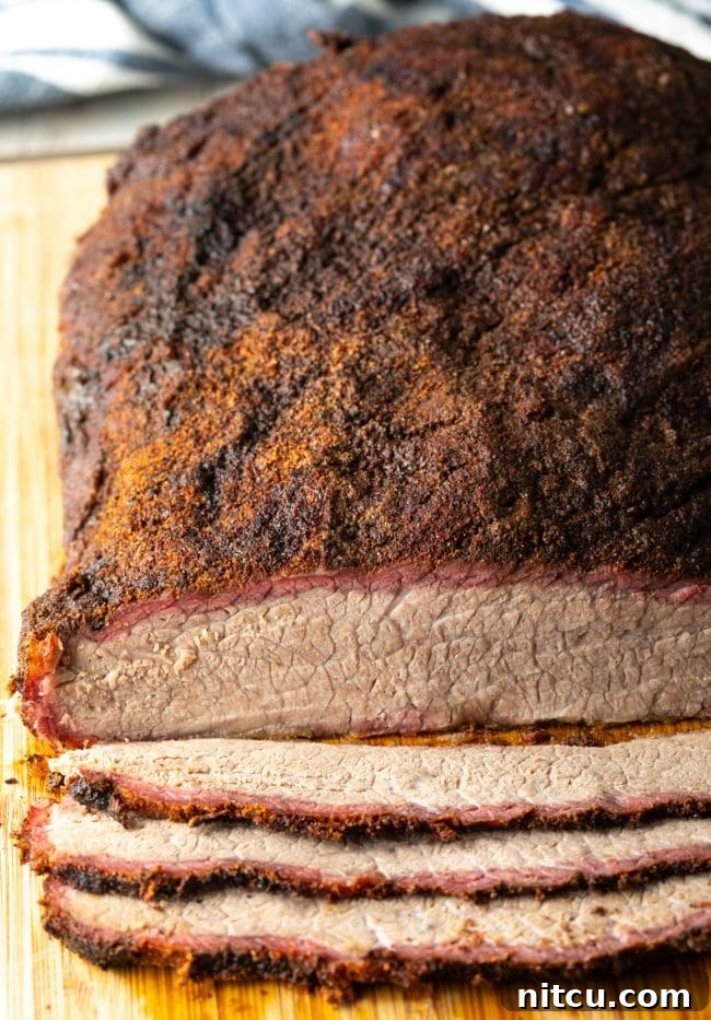 Overhead view of perfectly sliced beef brisket on a cutting board, ready to serve.