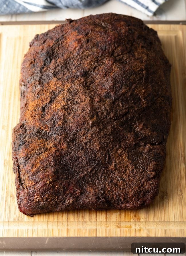 Beef brisket after being smoked and before being sliced, showcasing its perfect bark.