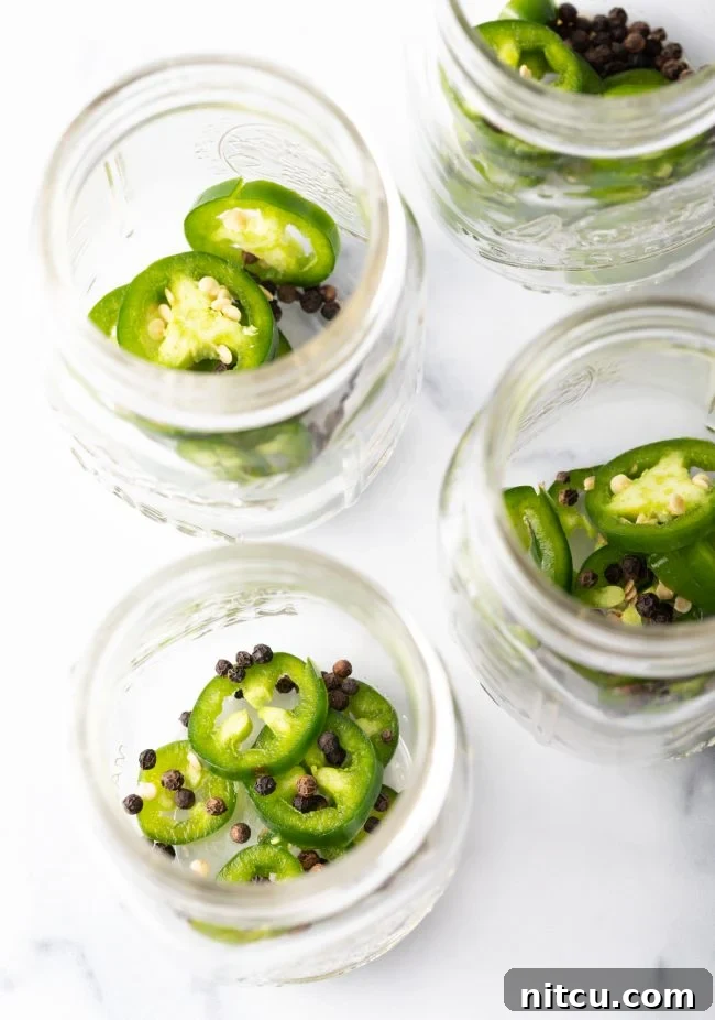 jalapeno slices and peppercorns in jars