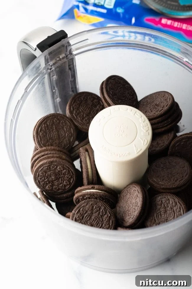 Crushed Oreo cookies in a food processor, ready for the crust.