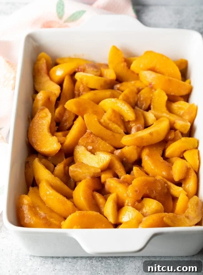 sliced peaches in a baking dish