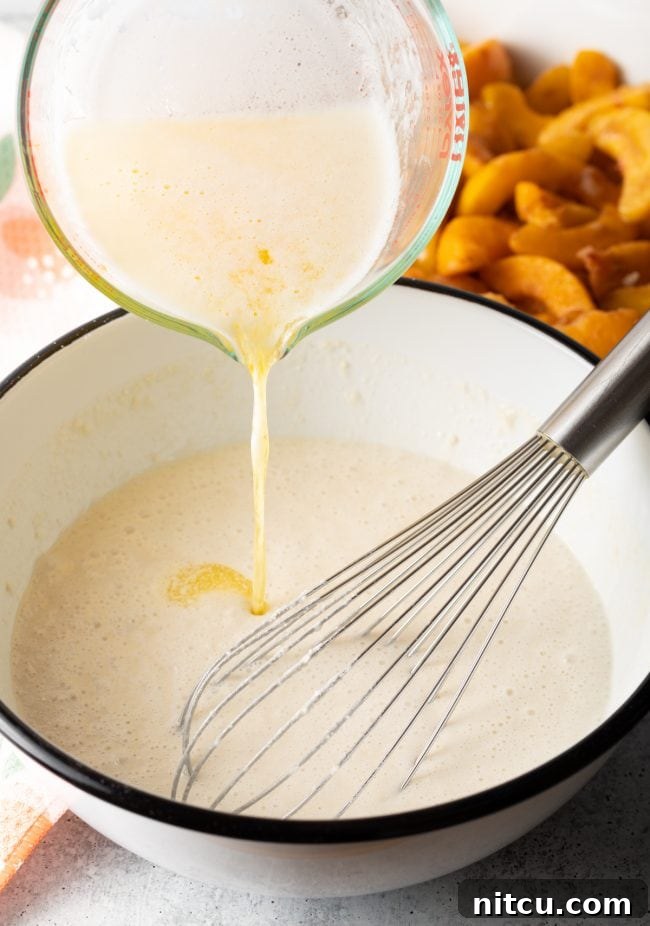 whisking melted butter into the batter
