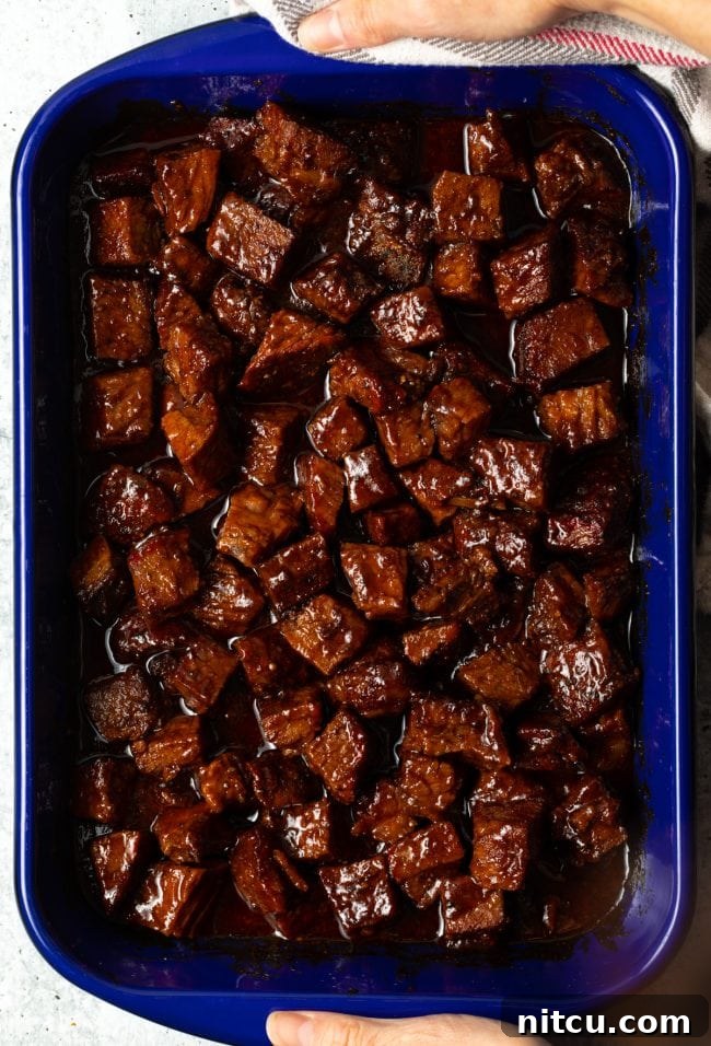 Overhead view of perfectly glazed brisket burnt ends glistening with barbecue sauce.