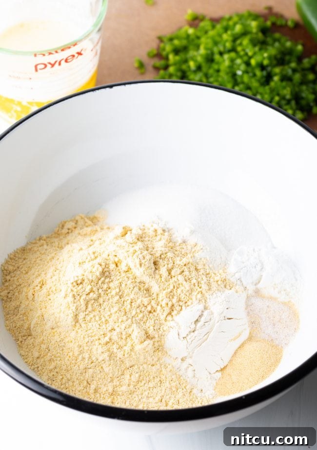Close-up of a bowl with dry ingredients for cornbread, ready to be combined.