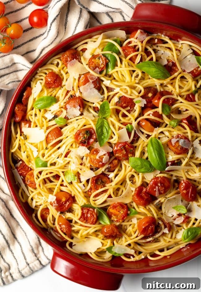 A large pot of perfectly cooked spaghetti coated in a rich, homemade roasted cherry tomato sauce.