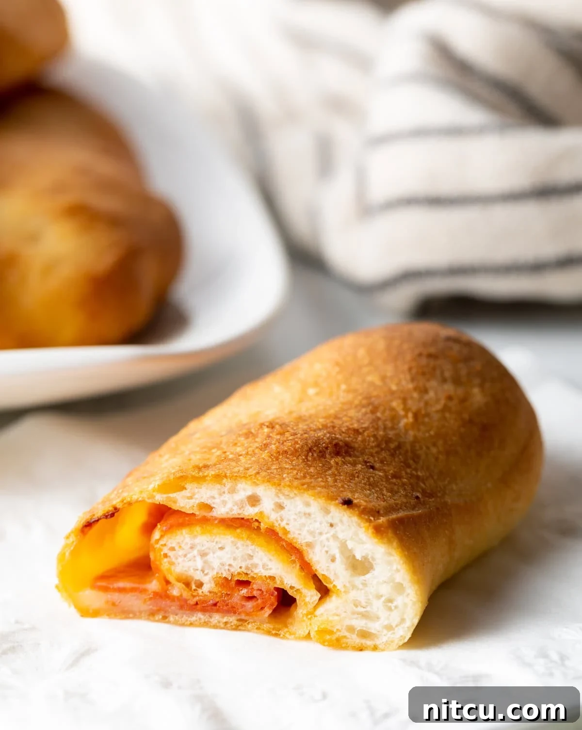 sliced pepperoni roll showing inner pepperoni and cheese