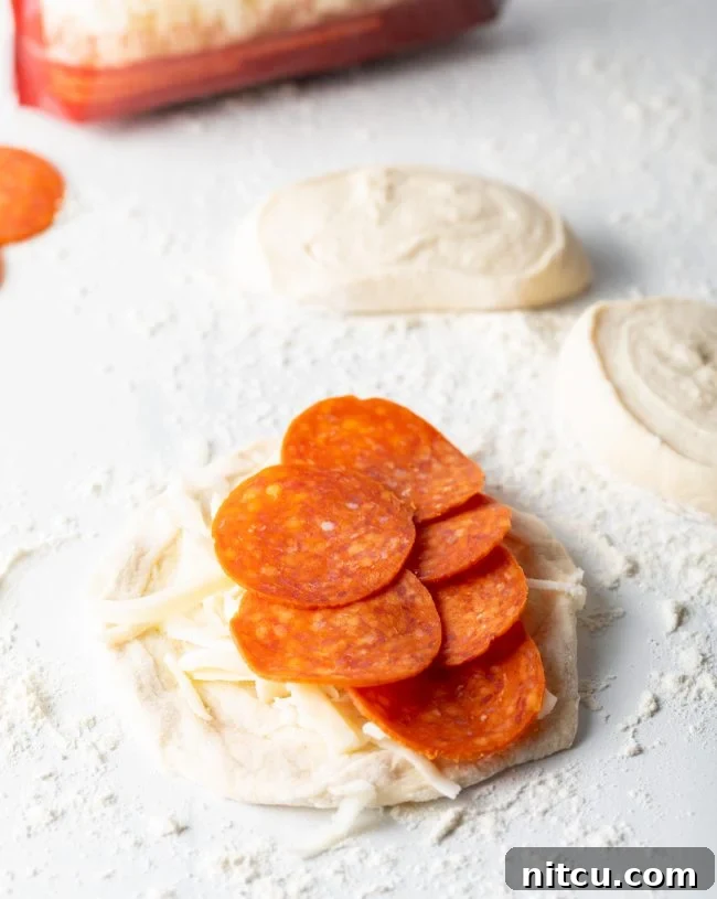 Pepperoni on a piece of pizza dough..