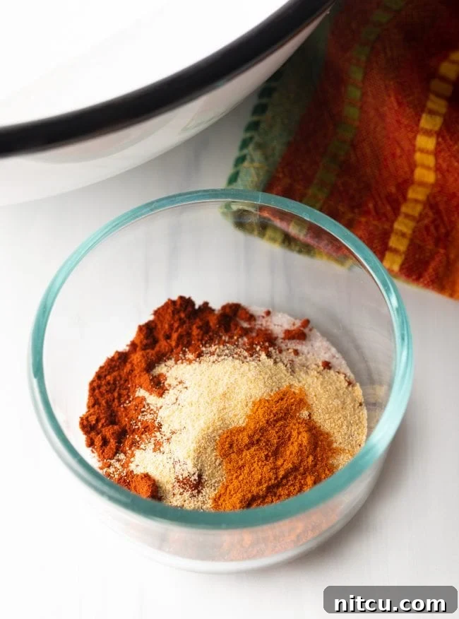 Small glass bowl containing a vibrant mix of Patatas Bravas spices