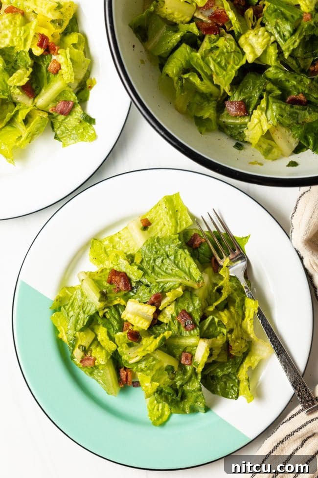 top view two plates with southern lettuce salad with a form and salad bowl in the background