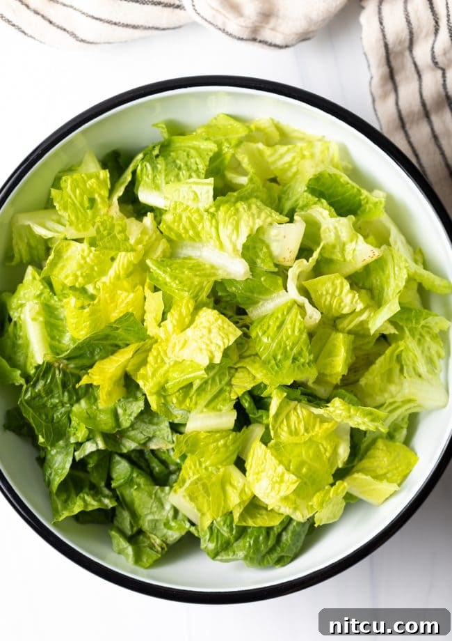 chopped romaine in a large white bowl