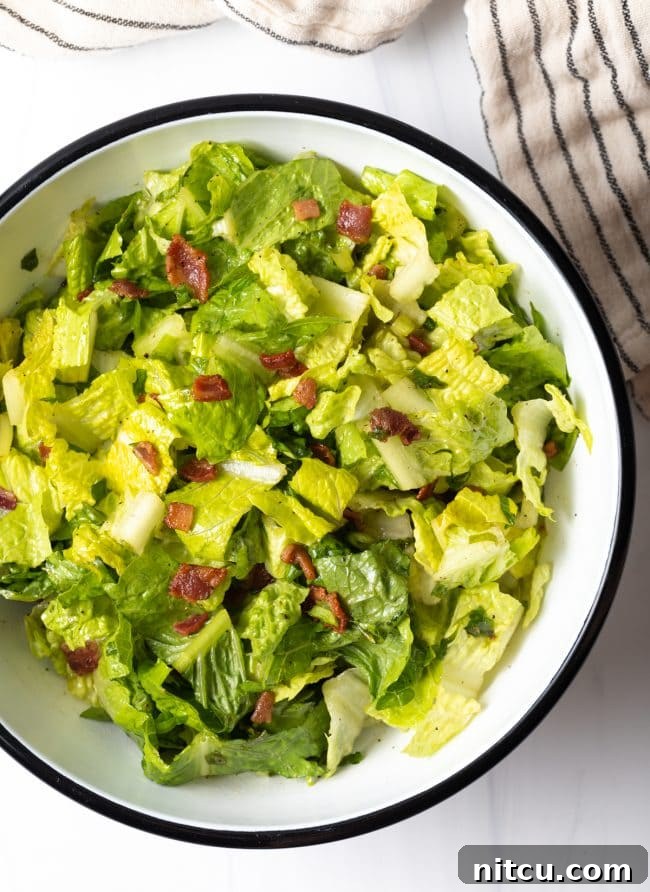 top view salad bowl with chopped romaine lettuce and warm bacon dressing
