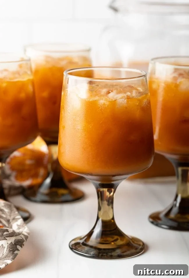 side view of goblets with iced orange pumpkin juice