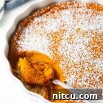A delicious Carrot Souffle Casserole, garnished with powdered sugar.