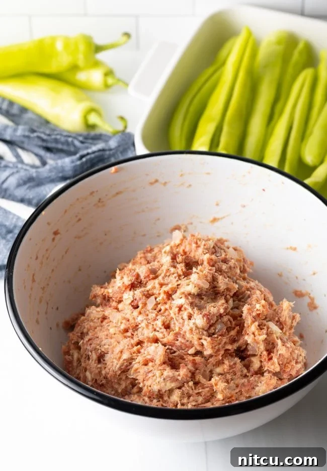 A bowl of thoroughly mixed sausage stuffing, showing the creamy texture and integrated ingredients