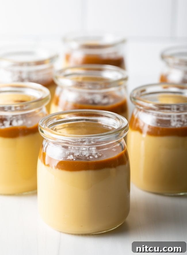 Budino Dessert Recipe - side view several glass jars filled with caramel and butterscotch pudding