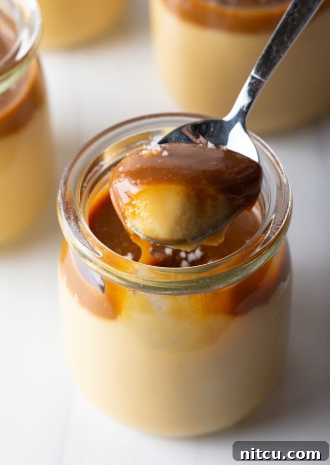 spoon scooping budino with butterscotch and salted caramel topping