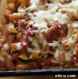 Close-up of baked penne with broccoli, showing texture and golden top