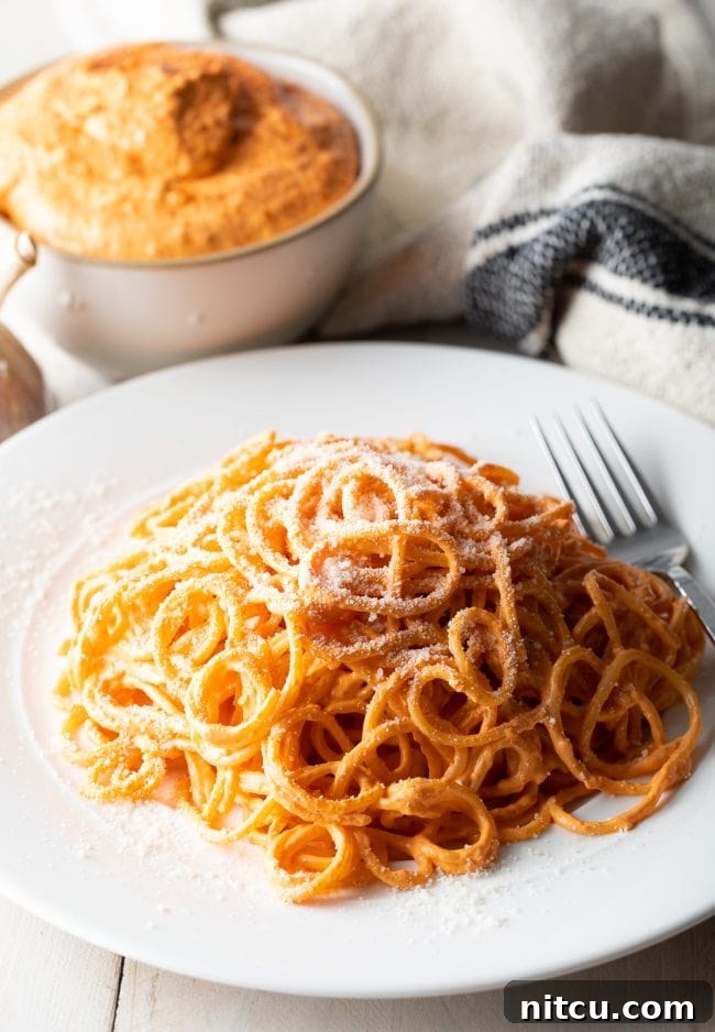 Fast Red Pepper Sauce served with toodles on a plate. 
