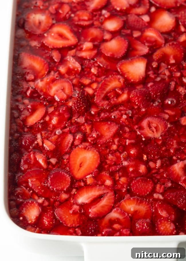 Top view of a chilled and solidified strawberry jello salad, ready to be served.