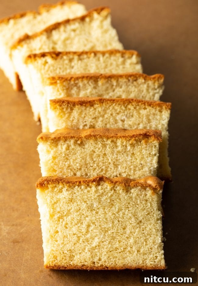 top down view of slices of castella cake on a brown cutting board