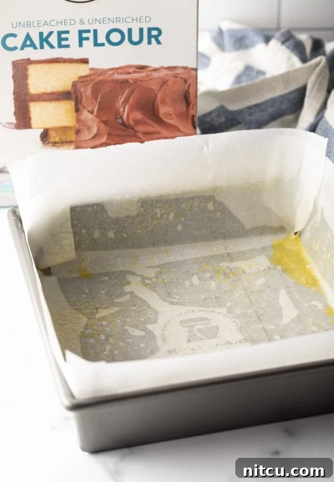 parchment paper lined baking square with box of cake flour in the background