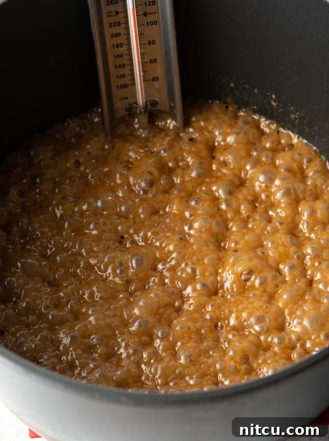 Close-up of a pot filled with bubbling golden caramel, perfectly ready for the next step.
