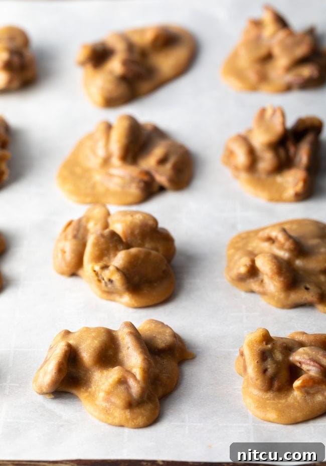 Top view of parchment paper with a multitude of homemade candies neatly arranged and cooling.