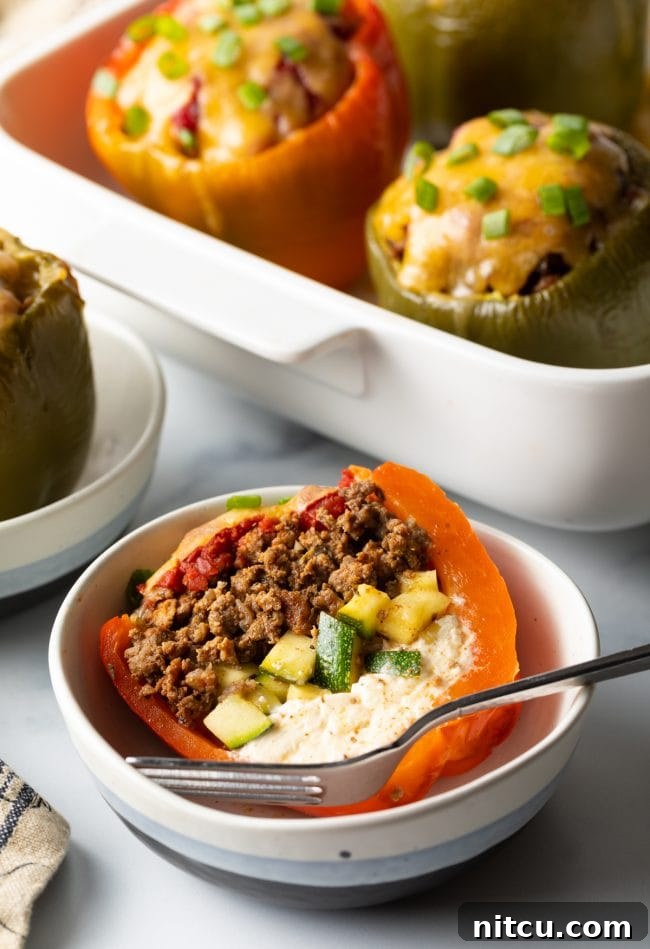 Mediterranean stuffed bell pepper without rice cut in half in a bowl with fork.