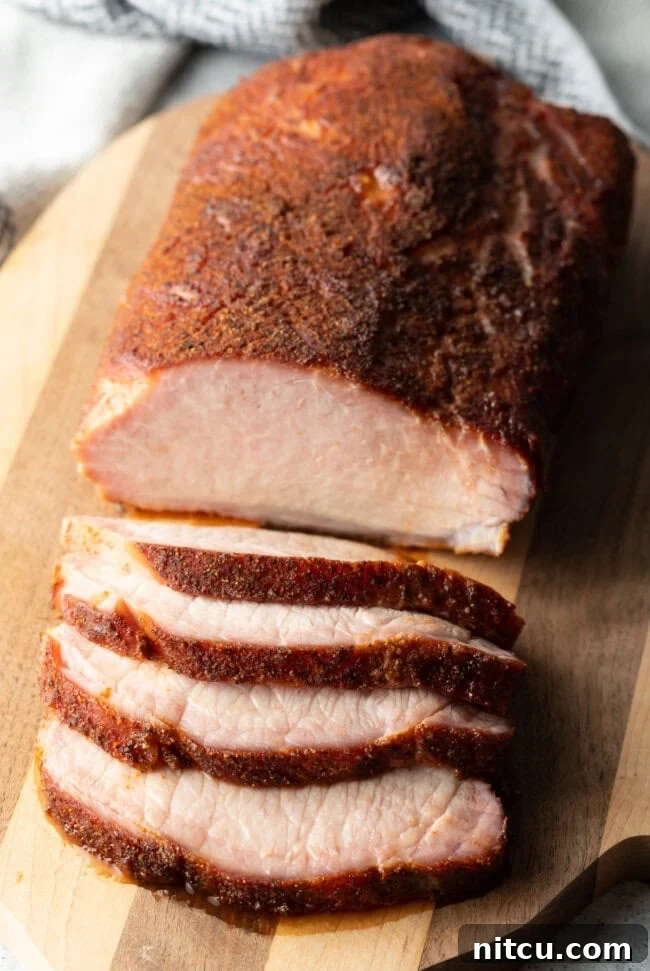 Smoked Pork Loin Rub - carved smoked pork loin on a wood board