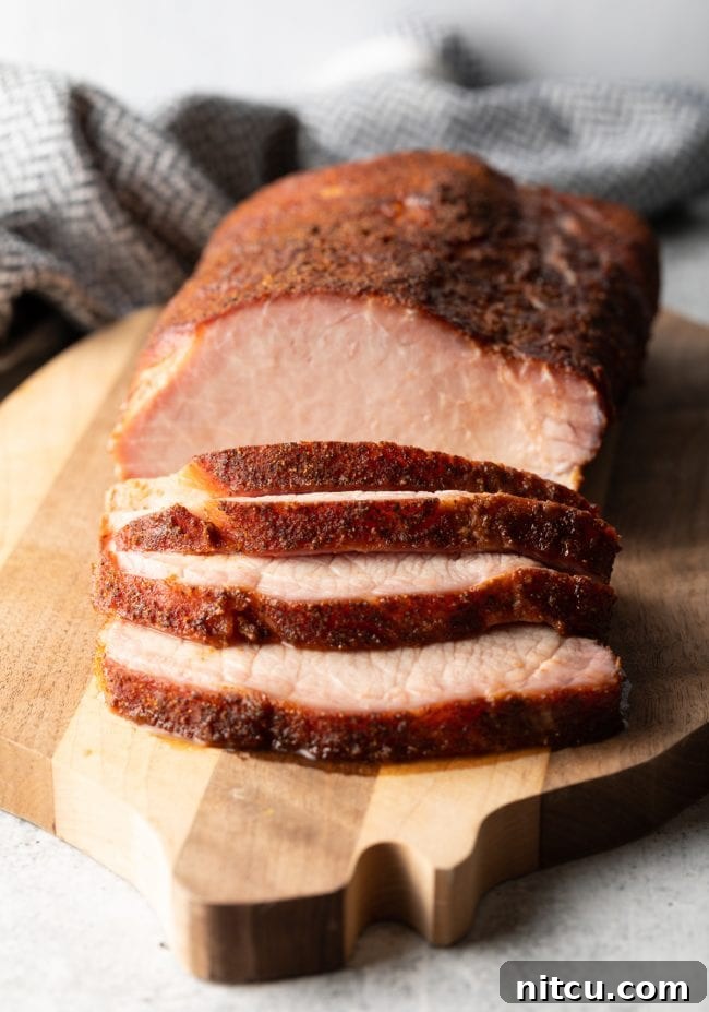 close view sliced smoked pork loin on a cutting board