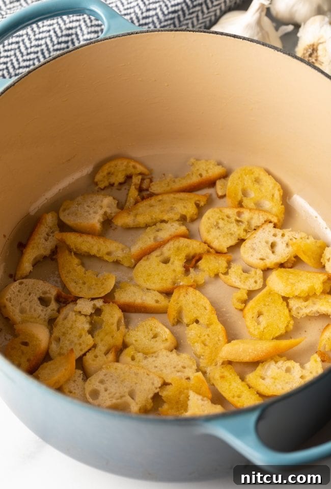 slices of baguette toasted with oil in a large pot
