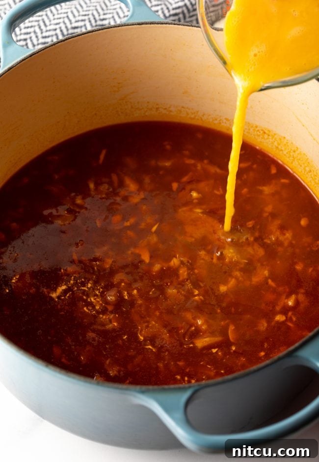adding beaten eggs to the pot