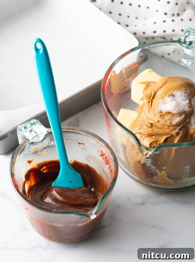Separated ingredients for peanut butter fudge: chocolate chips in one glass bowl, and a mixture of peanut butter, butter, and powdered sugar in another.