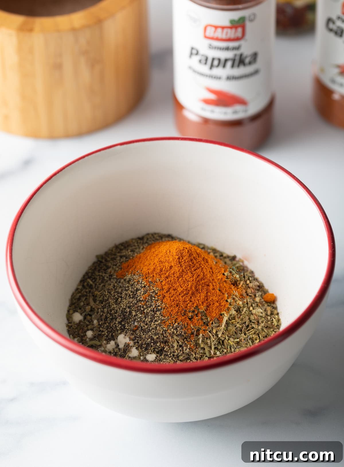 Spices added to a small bowl.