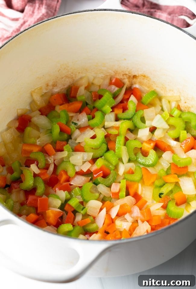 Sauteed 'holy trinity' vegetables in a pot.