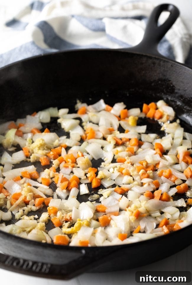 Fresh vegetables being sautéed in a hot pan, vibrant and fragrant.
