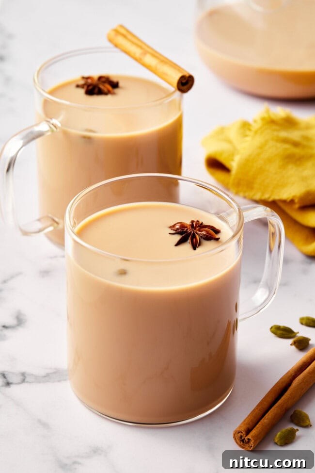 Clear mugs filled with rich, frothy chai tea, ready to be savored for their aromatic warmth and comforting flavor.