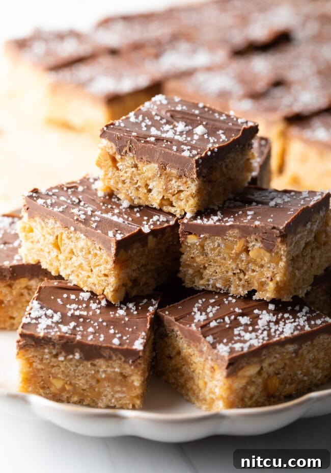 Plate stacked 3 treats high, filled with Scotcharoos.